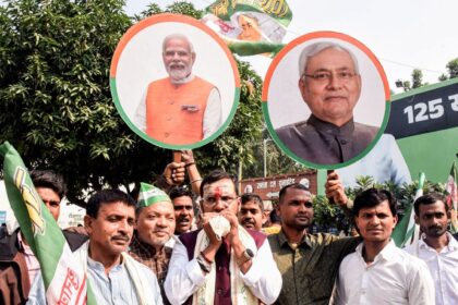 Patna, Nov 14 (ANI): Janata Dal (United) (JD-U) supporters hold placards of Prime Minister Narendra Modi and Bihar Chief Minister Nitish Kumar as they celebrate NDA's lead in the vote counting of the Bihar Assembly election 2025 at the party office, in Patna on Friday. (ANI Photo)