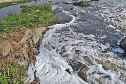 What are the downstream One Health impacts when untreated wastewater is released into rivers?