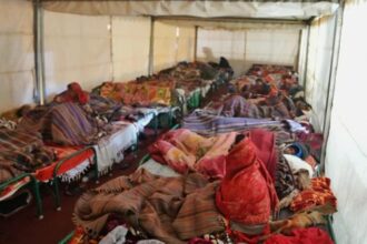 Cancer support: People resting in makeshift tents outside AIIMS Metro station, Gate no. 2. (Express Photo by Abhinav Saha)
