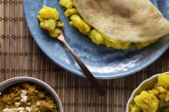 A freshly served plain dosa on a plate, a popular South Indian breakfast food
