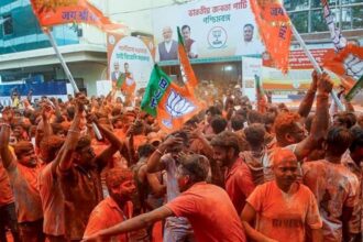 BJP supporters apply 'gulal' amid celebrations during vote tabulation on the day of West Bengal Assembly election results