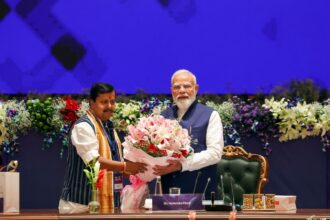Prime Minister Narendra Modi is being felicitated by BJP National President Nitin Nabin as he chairs a high-level NDA Conclave at the Bharat Mandapam. (ANI Photo)