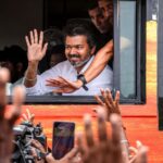 Tamil Nadu Chief Minister Vijay greets supporters during his visit to Karur, where he is scheduled to meet families affected by the 2025 stampede and attend official events. (File Photo/Enhanced using AI)
