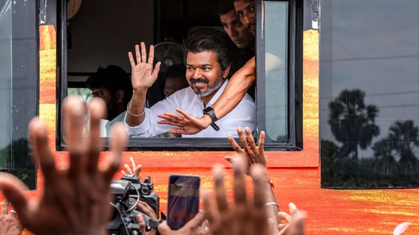 Tamil Nadu Chief Minister Vijay greets supporters during his visit to Karur, where he is scheduled to meet families affected by the 2025 stampede and attend official events. (File Photo/Enhanced using AI)