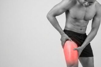 Person experiencing outer thigh pain while standing