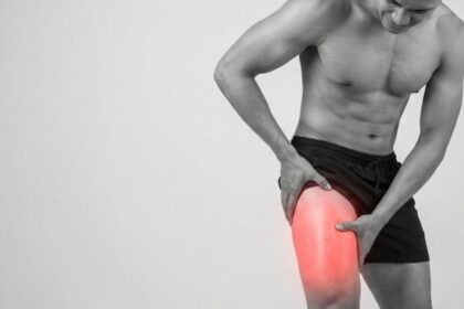 Person experiencing outer thigh pain while standing