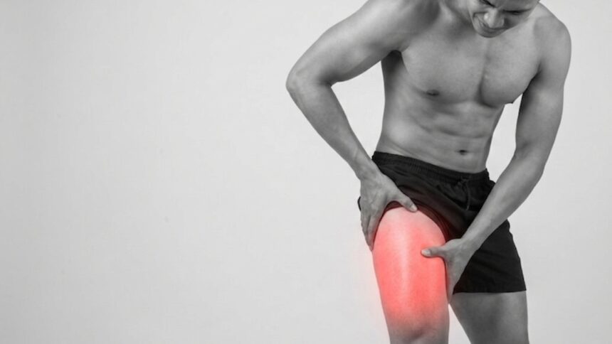 Person experiencing outer thigh pain while standing