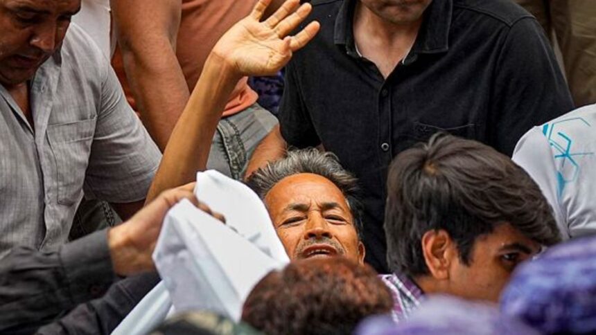 Activist Sonam Wangchuk, who has been on an indefinite hunger strike for 21 days, waves as he is shifted to a hospital from Jantar Mantar, in New Delhi. (PTI Photo)